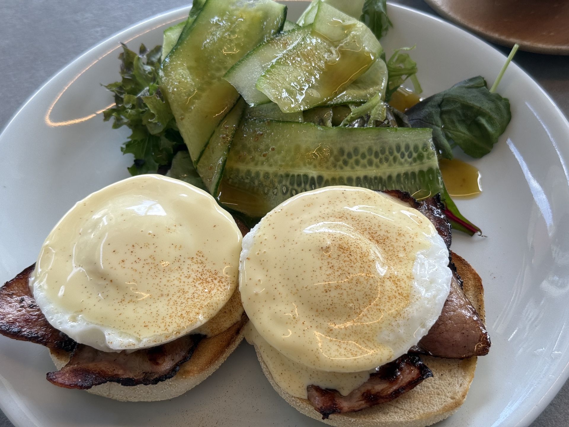 Eggs Benedict with bacon and salad at The Cookhouse in Limassol